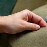 Hands holding sustainable fabric swatches in natural light